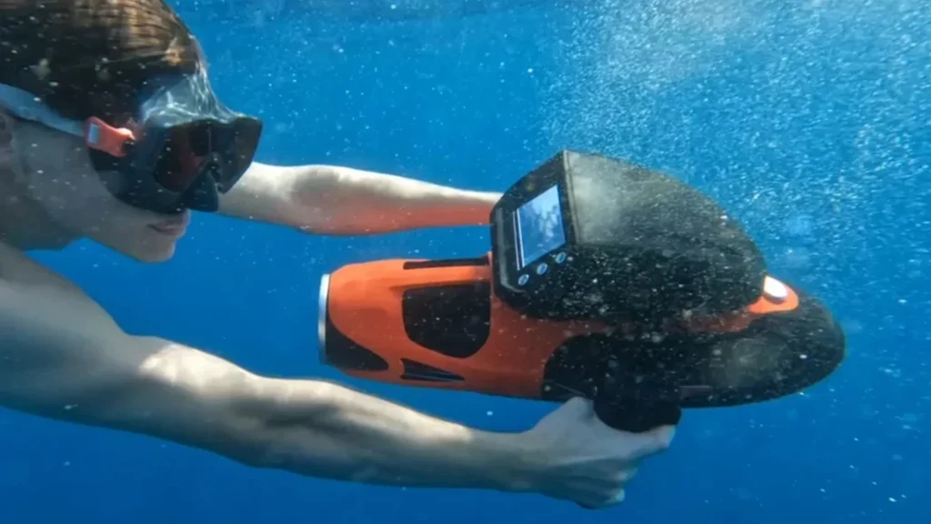 Guest using a FunSeaker Sublue Vapor underwater scooter in the crystal-clear waters of Anguilla during a private yacht charter.